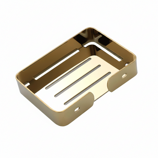 Gold-colored stainless steel soap dish with a rectangular shape, featuring a slotted bottom and a small loop on one side, shown on a reflective white surface.

