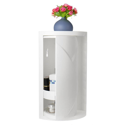 A white cylindrical corner shelf with a glass door, shown open with toiletries inside and a blue vase of pink flowers on top, against a plain white background.

